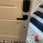 black digital combination lock view from inside deadbolt and separate lever handle on residential white door