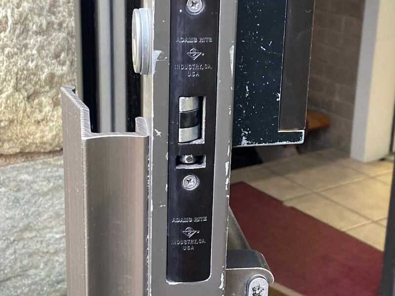 mortis lock with view of push handle on commercial glass door
